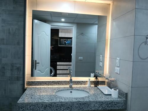 a bathroom with a sink and a large mirror at scandic resort sea view balcony free wi fi in Hurghada