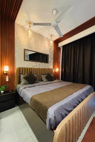 a bedroom with a large bed with a ceiling at Luxury sup nova in New Delhi