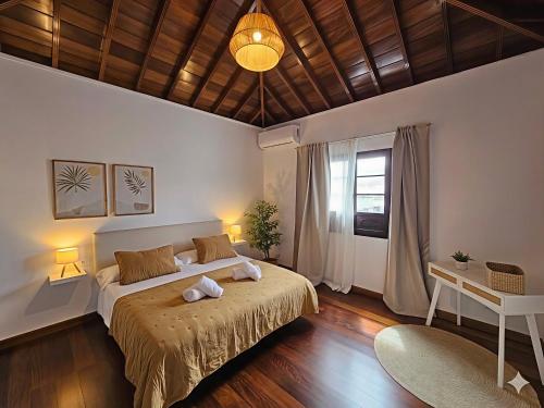 a bedroom with a large bed and a table at Casona IROKO in La Costa