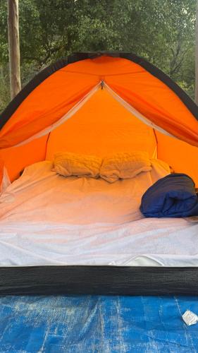a bed in an orange and blue tent at StNicholas Ranch Corfu Wild Camping 2 in Benitses