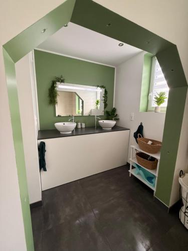 a bathroom with two sinks and a mirror at Duplex-Cocon-Proximité - frontières in Hombourg-Haut
