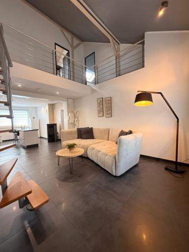 a living room with a couch and a table at Duplex-Cocon-Proximité - frontières in Hombourg-Haut