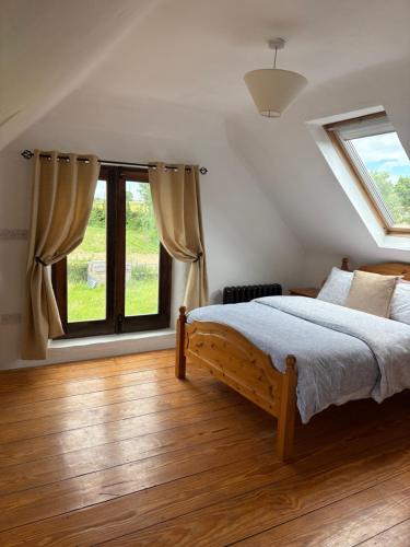 a bedroom with a bed and a large window at THE FARMHOUSE Room 2 in Balcunnin