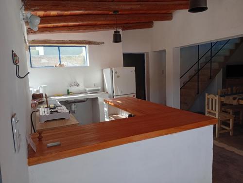 a kitchen with a counter top and a refrigerator at Cabañas don Julio in Maimará