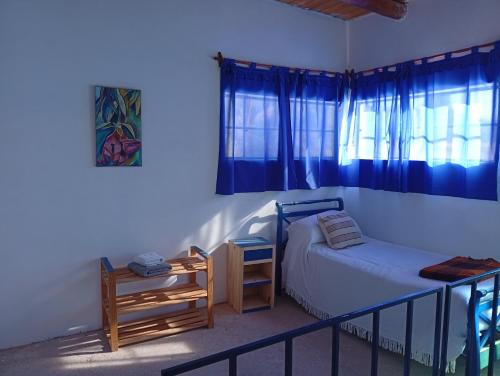 a small bedroom with a bed and a table at Cabañas don Julio in Maimará