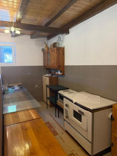 a kitchen with a white stove top oven in a room at DreamHouse Grebaje in Gusinje