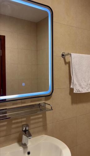 a mirror above a sink in a bathroom at aura alraha village in Aqaba