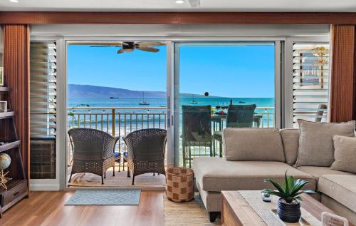 a living room with a view of the ocean at Lahaina Roads 306 in Lahaina