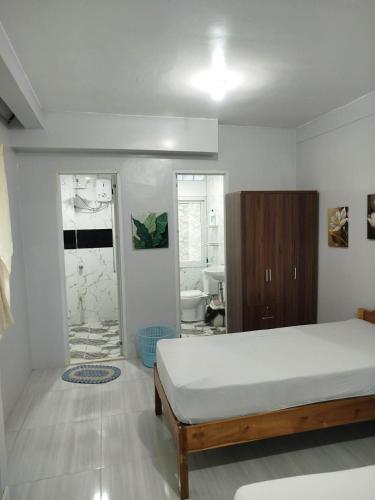 a bedroom with a bed and a bathroom at Nenita in Baybay