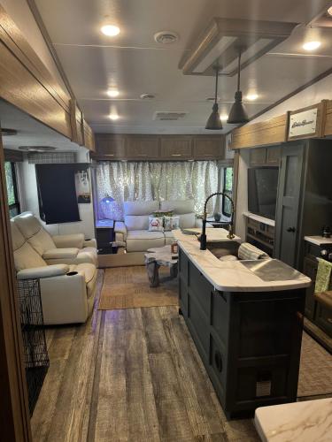 a living room with a kitchen and a living room with a couch at EL Camper KW in Key West