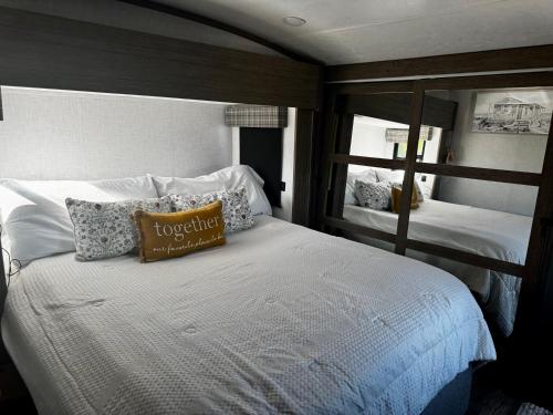 a bedroom with two beds and a mirror at EL Camper KW in Key West