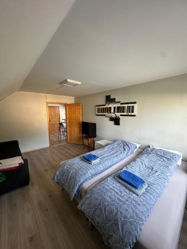 a bedroom with a large bed with blue sheets at Loft apartment with 3 bedrooms in Trondheim