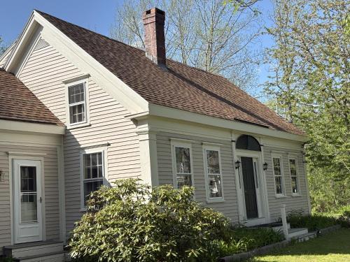 a white house with a chimney on top of it at Hawks House Inn in Walpole