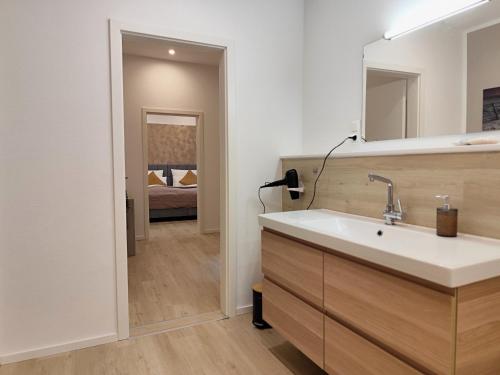 a bathroom with a sink and a mirror at ApartZ - Celle - CityQuartier - bis 15 Personen - 4 Apartments in Celle