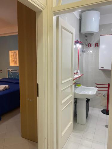 an open door to a bathroom with a sink at Sole Mare da Tina in Cittadella del Capo