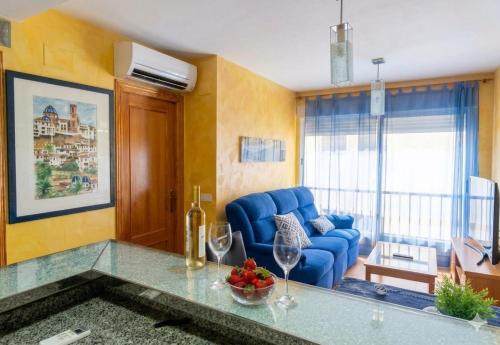 a living room with a blue couch and a table at Romantic - Garaje Incluido & ApartamentosAltea in Altea