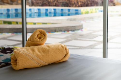 a towel animal sitting on a table in front of a window at SeaSide Hotel Galapagos in Puerto Baquerizo Moreno
