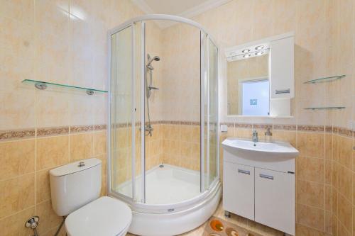 a bathroom with a shower and a toilet and a sink at Private Pool Villa with Garden & Forest View in Fethiye