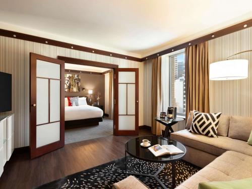 a living room with a couch and a bed at Sofitel Philadelphia at Rittenhouse Square in Philadelphia