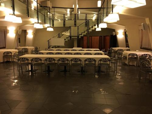 a large room with tables and chairs and lights at Grande Albergo Potenza in Potenza