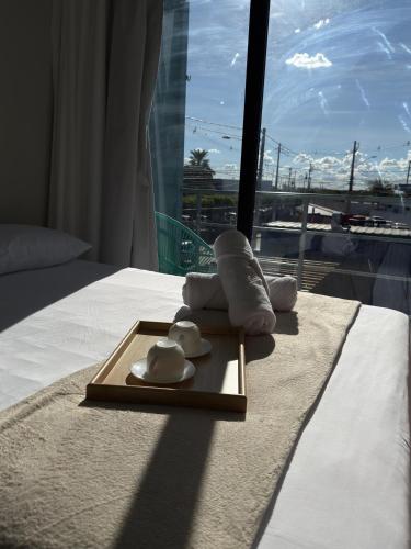 a hotel room with a tray with towels and a window at Riovale Container Lofts in Petrolina