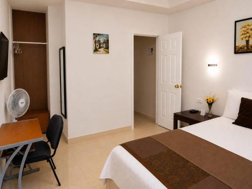 a hotel room with a bed and a desk and a chair at BCHotel in Siguatepeque