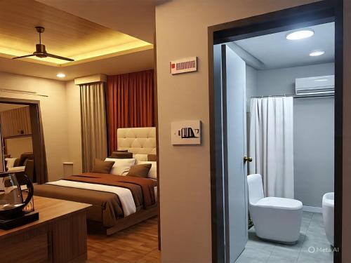a hotel room with a bed and a bathroom at Samal Hillside Inn in Samal