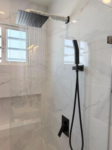 a shower with a shower head in a bathroom at Casa Brisas del Sur in San Juan del Sur