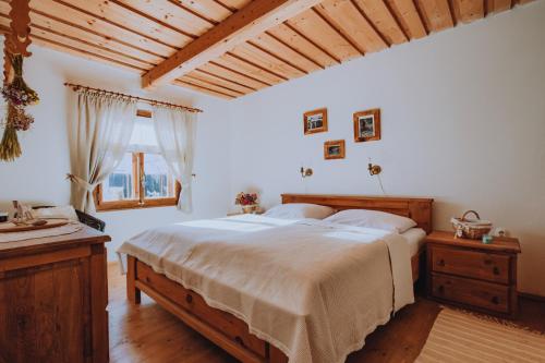 a bedroom with a large bed and a window at Babičkina Chalúpka in Pohorelá