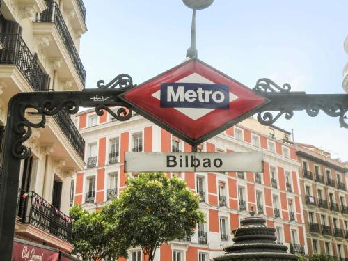 a metro sign in front of a building at Ibis Styles Madrid Centro Maravillas in Madrid