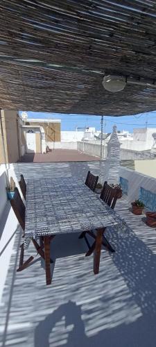 a table and chairs sitting on a patio at Casa Fuseta-38 in Fuzeta