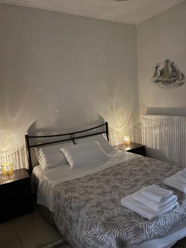a bedroom with a bed with towels on it at Sea And Sand Apartment in Nea Kallikrateia