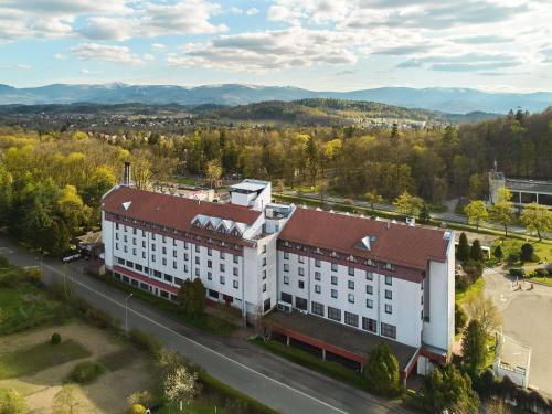 an overhead view of a white building with a red roof at Mercure Jelenia Góra in Jelenia Góra
