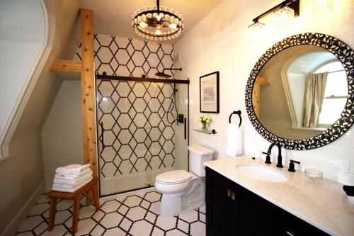 a bathroom with a sink and a toilet and a mirror at Garfield Inn in Port Austin
