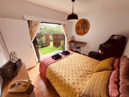 a bedroom with a bed and a desk and a window at The Royale Bundeena in Bundeena