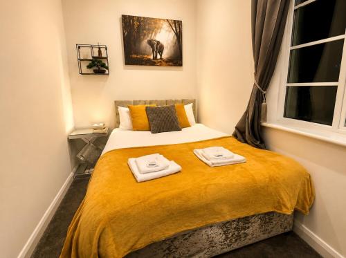 a small bedroom with a bed with towels on it at Nottingham City Centre 3 Bed Luxury Apartment in Nottingham