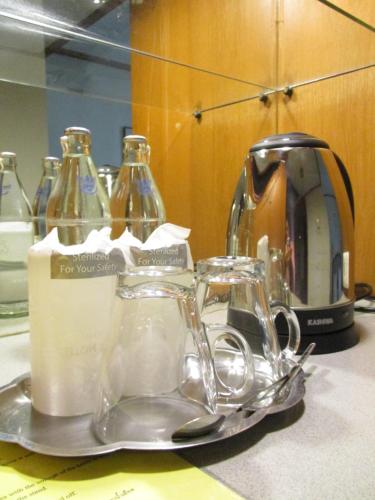 a tray with glass jars and a tea kettle at Kosit Hotel in Hat Yai