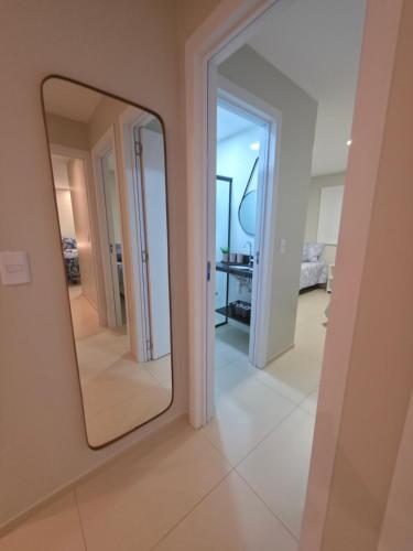 a mirror on a wall in a room at Refúgio à Beira-Rio em Condomínio Exclusivo in Barreirinhas