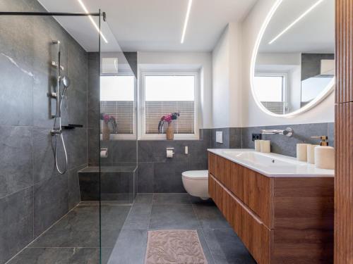 a bathroom with a sink and a toilet and a shower at Bruggerheim in Niedernsill