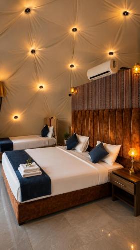 a bedroom with two beds in a tent at WADI RUM REGENCY BUBBLE lUXURY in Wadi Rum