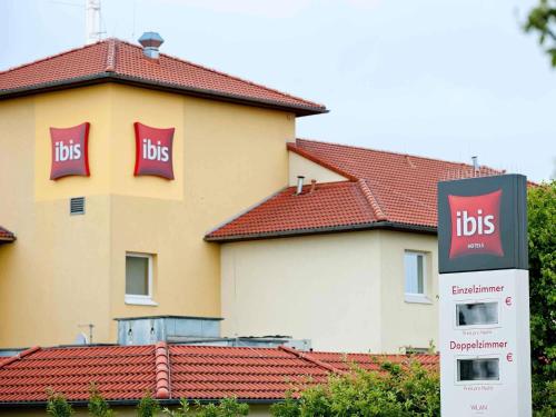 a building with a bus sign in front of it at ibis Hotel Köln Airport in Cologne