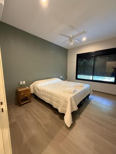 a bedroom with a bed and a ceiling fan at Casa Las Moras in Santiago del Estero