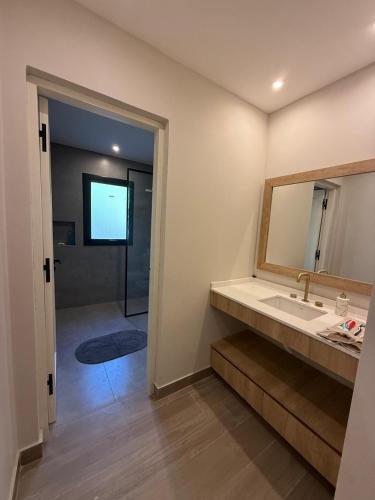 a bathroom with a sink and a mirror and a shower at Casa Las Moras in Santiago del Estero