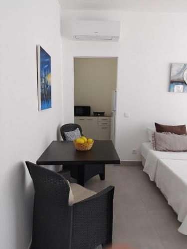 a room with a table and chairs and a bed at Cozy Burgau in Burgau