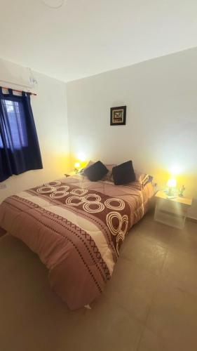 a bed in a bedroom with two lamps on at Julieta in La Rioja