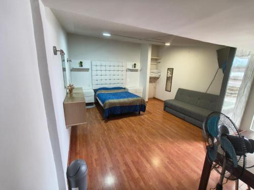 a living room with a bed and a couch at Loft Santa Rosa in Apizaco