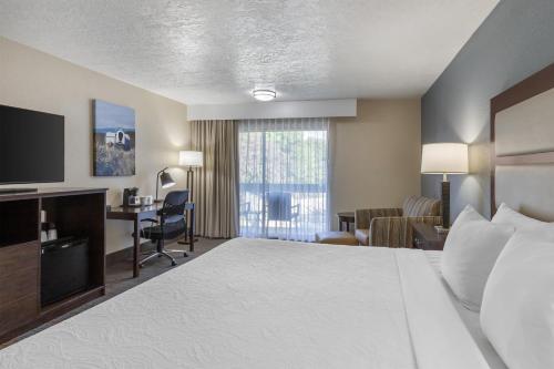 a hotel room with a bed and a desk at Best Western Sunridge Inn & Conference Center in Baker City