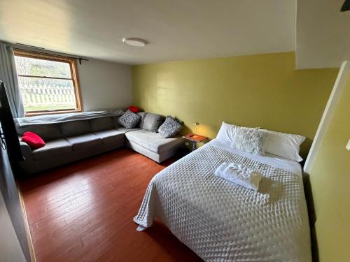a living room with a bed and a couch at Shiraz Suite in Calgary