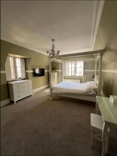 a bedroom with a bed and a dresser in a room at Dundee Beds in Dundee