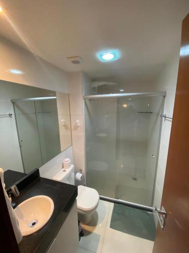 a bathroom with a shower and a toilet and a sink at Sol e Mar Solar do Atlântico-Tambaú-João Pessoa in João Pessoa